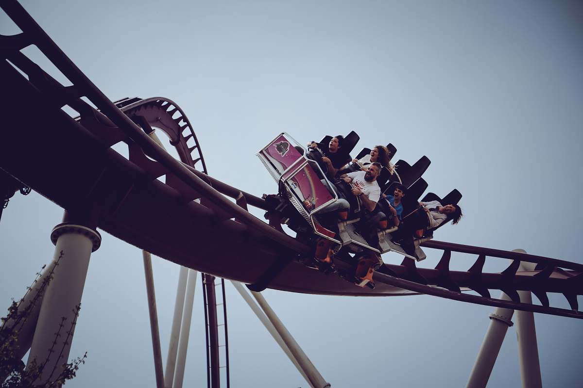amusement park six person riding on roller coaster at daytime coaster